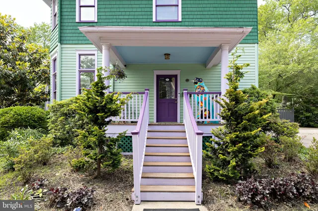 a view of a dining room with furniture and a mirror