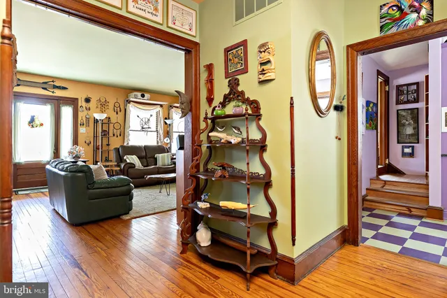 a kitchen with stainless steel appliances kitchen island granite countertop a white table and chairs in it