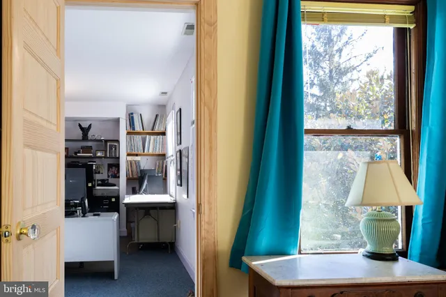 a view of closet with clothes and shoes