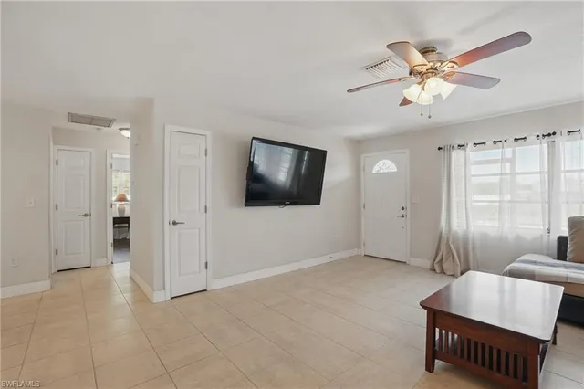 a living room with furniture and a ceiling fan