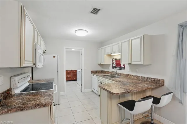 a kitchen with stainless steel appliances granite countertop a stove sink and cabinets