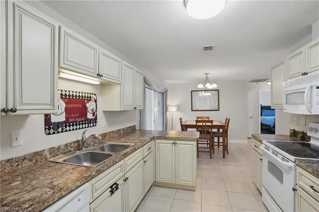 a kitchen with granite countertop sink cabinets and stainless steel appliances