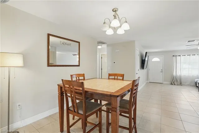 a view of a dining room with furniture and chandelier