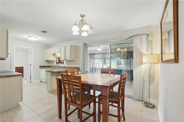 a view of a dining room with furniture and chandelier