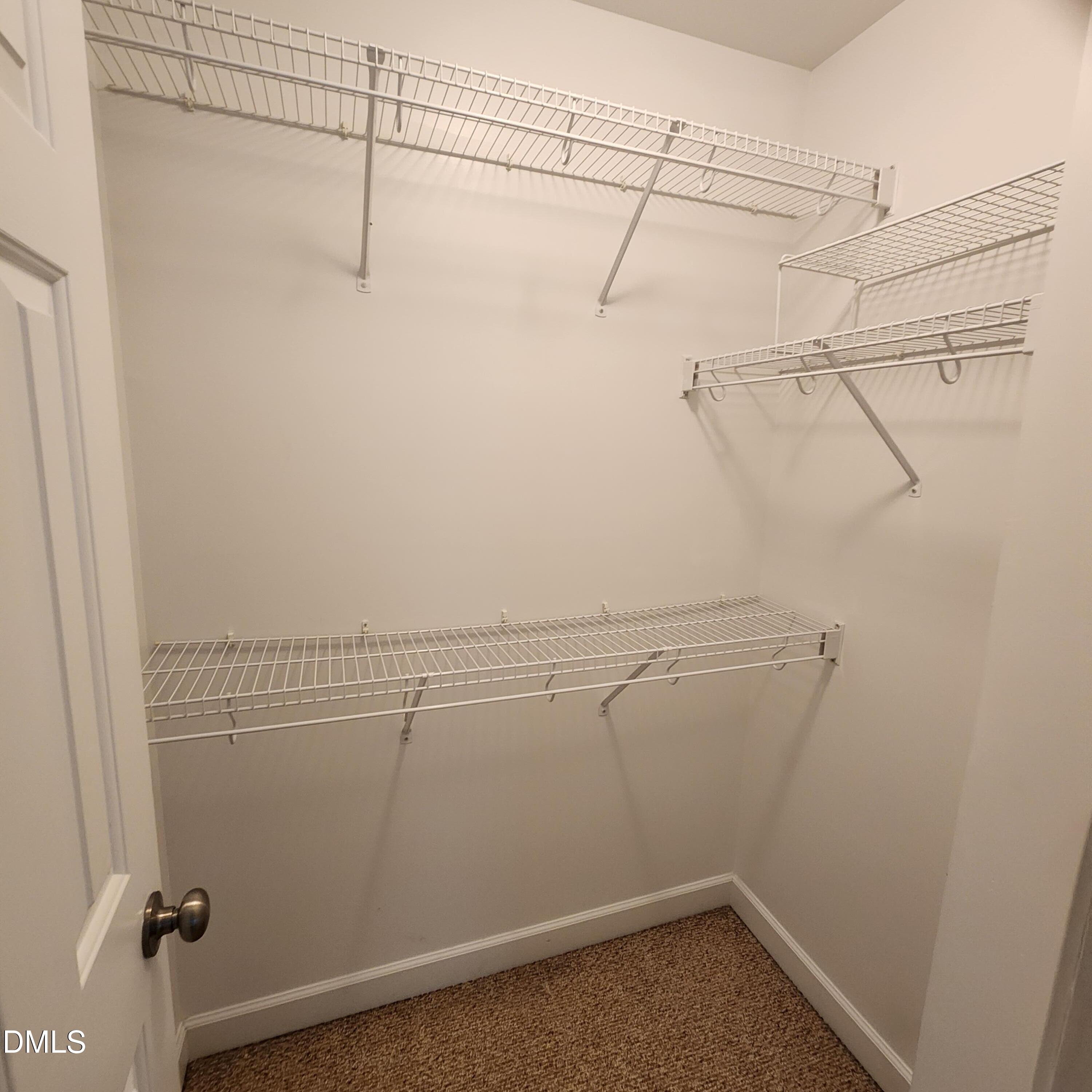 4916 Morning Edge Drive Raleigh, NC 27613 - Photo 16 of 26 a view of a room with racks on the wall