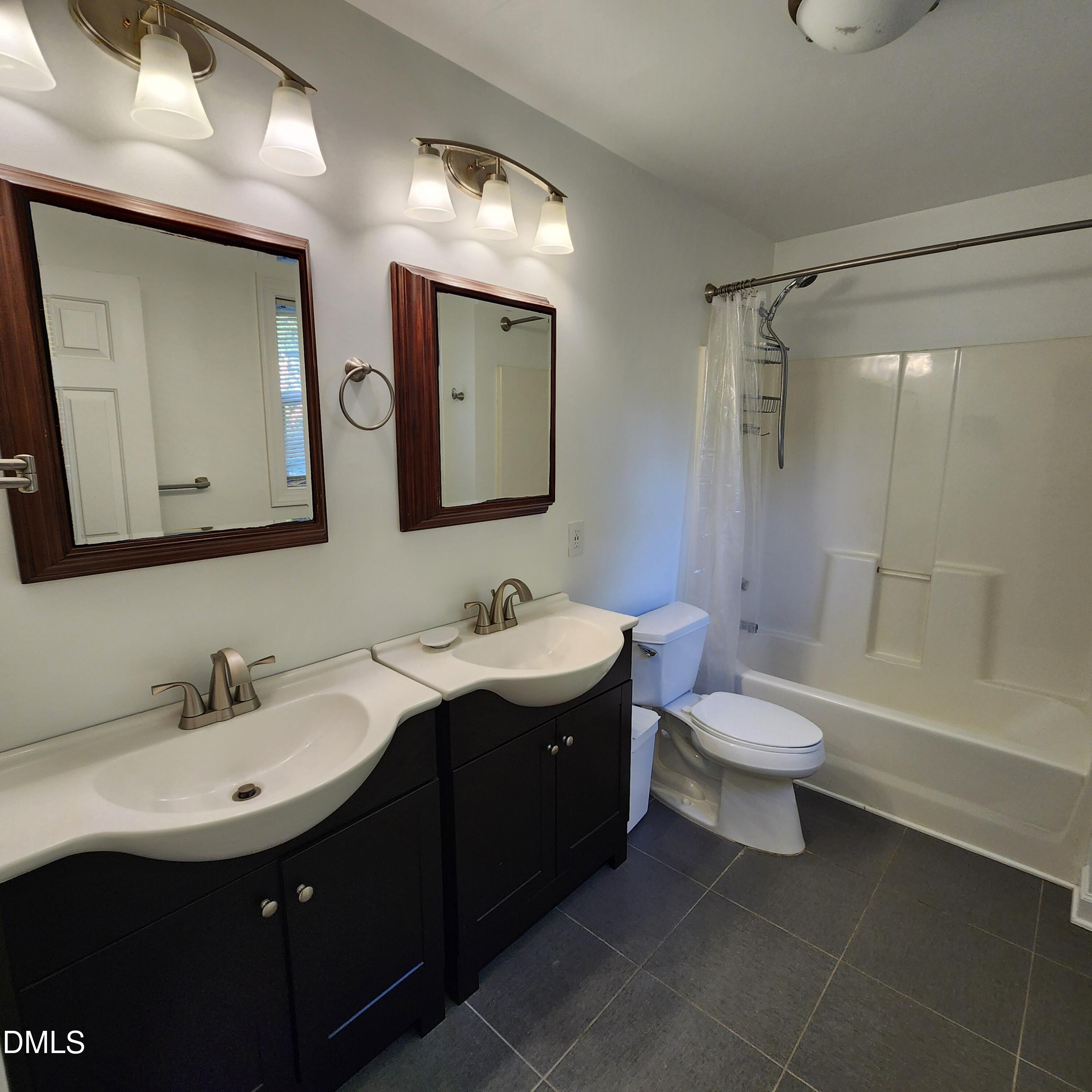 4916 Morning Edge Drive Raleigh, NC 27613 - Photo 18 of 26 a bathroom with a toilet sink and mirror