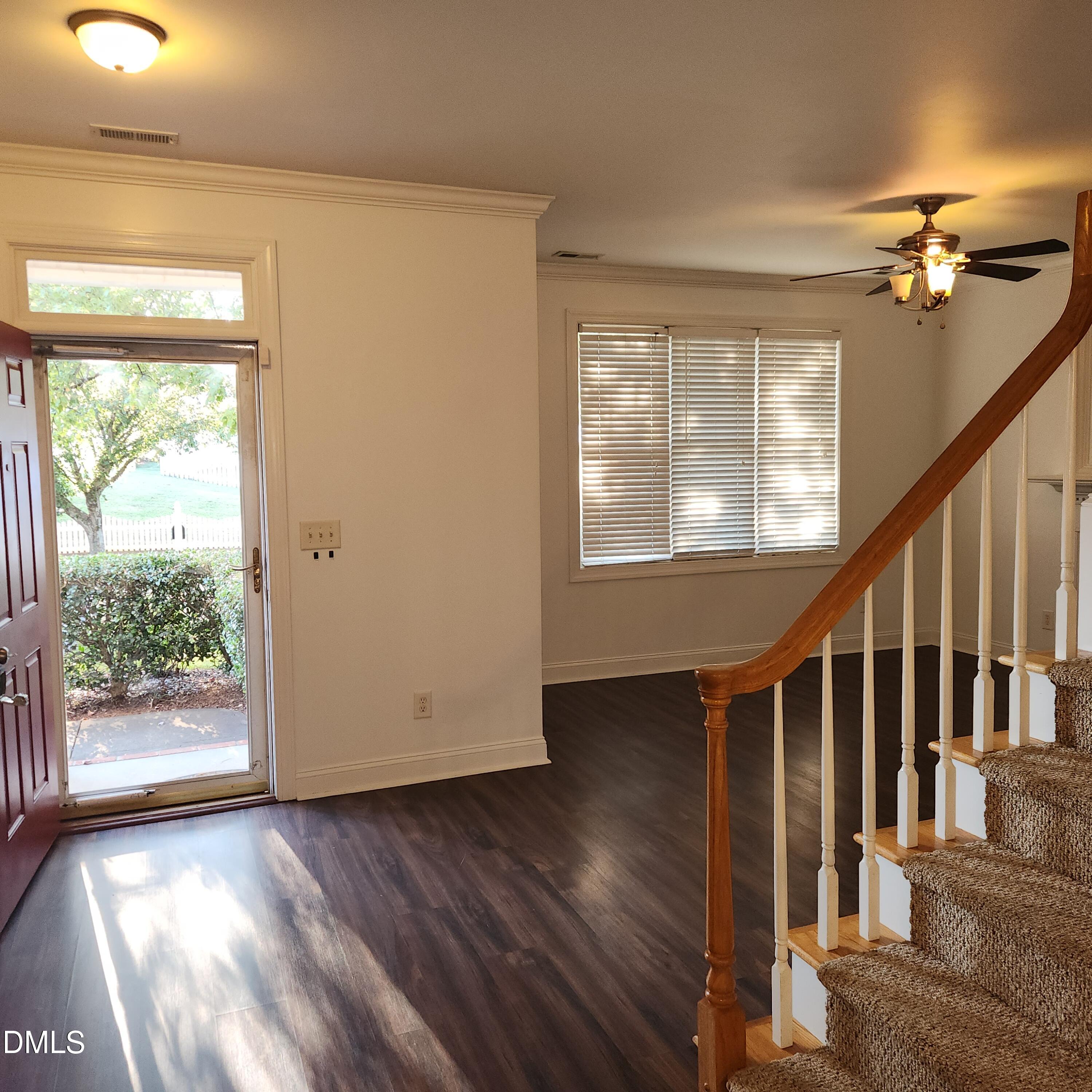 4916 Morning Edge Drive Raleigh, NC 27613 - Photo 19 of 26 a view of an empty room with wooden floor and windows