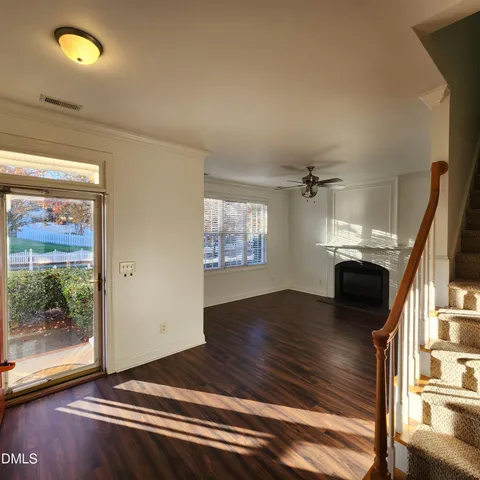 a view of an empty room with a fireplace and a window