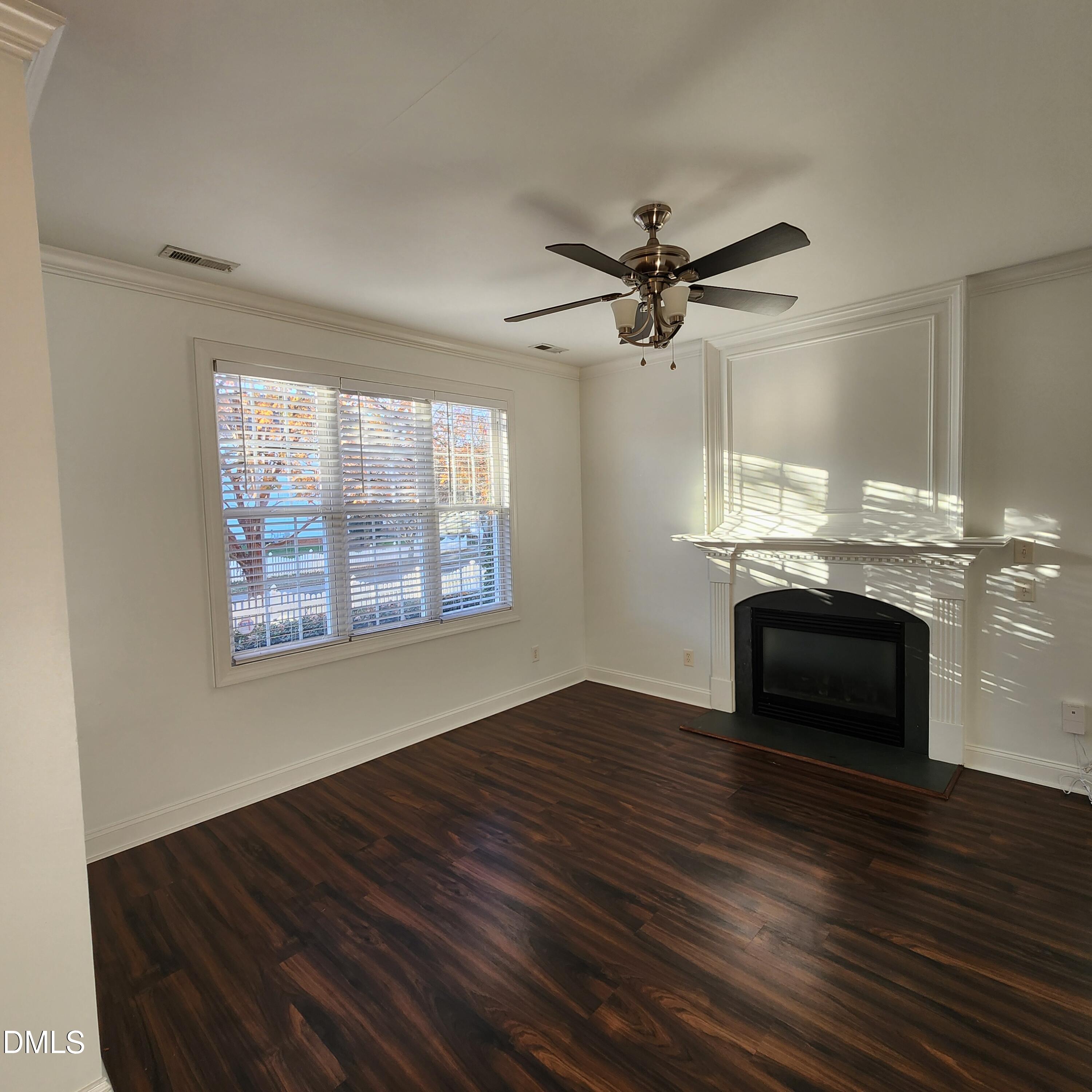 4916 Morning Edge Drive Raleigh, NC 27613 - Photo 10 of 26 a view of an empty room with a fireplace and a window