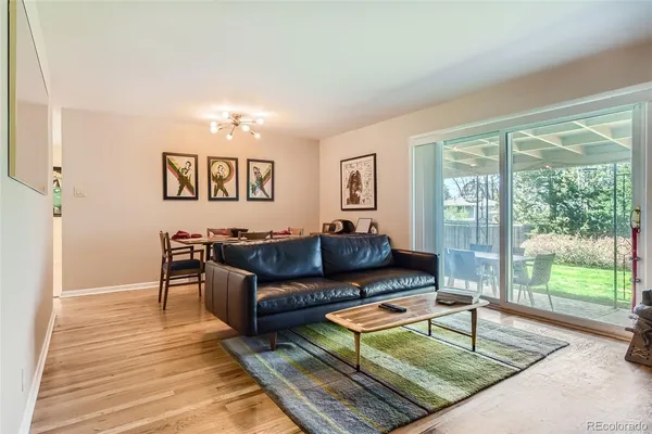 a living room with furniture and a floor to ceiling window