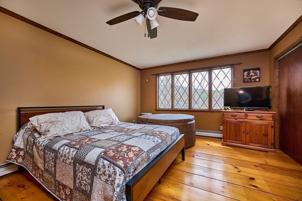 14 East Hawley Road Charlemont, MA 01339 - Photo 21 of 42 a bedroom with a large bed and a flat screen tv