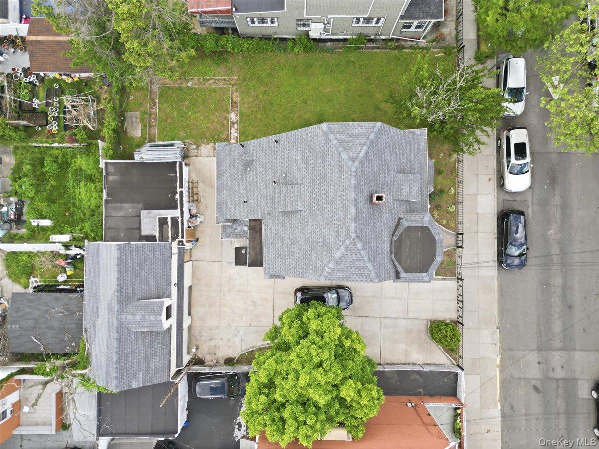 844-48 East 215th Street Bronx, NY 10467 - Photo 7 of 13 an aerial view of residential houses with outdoor space and swimming pool