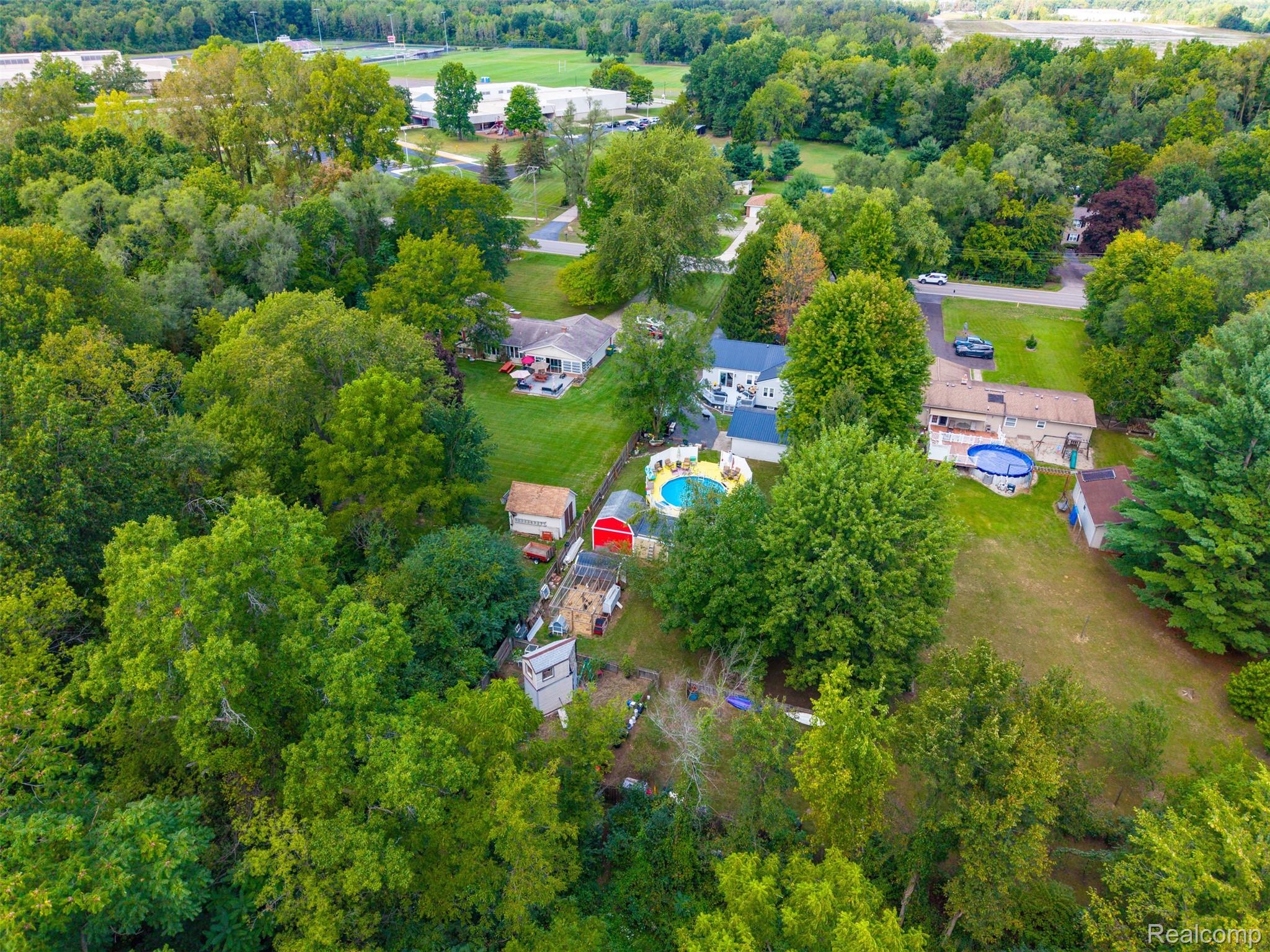36739 Wick Road Romulus, MI 48174 - Photo 49 of 56 Aerial perspective showcasing a residential property with an above-ground pool and surrounding green spaces
