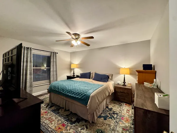 a bedroom with a bed and a chandelier