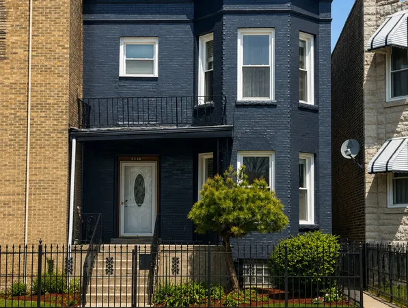 a front view of a house with plants
