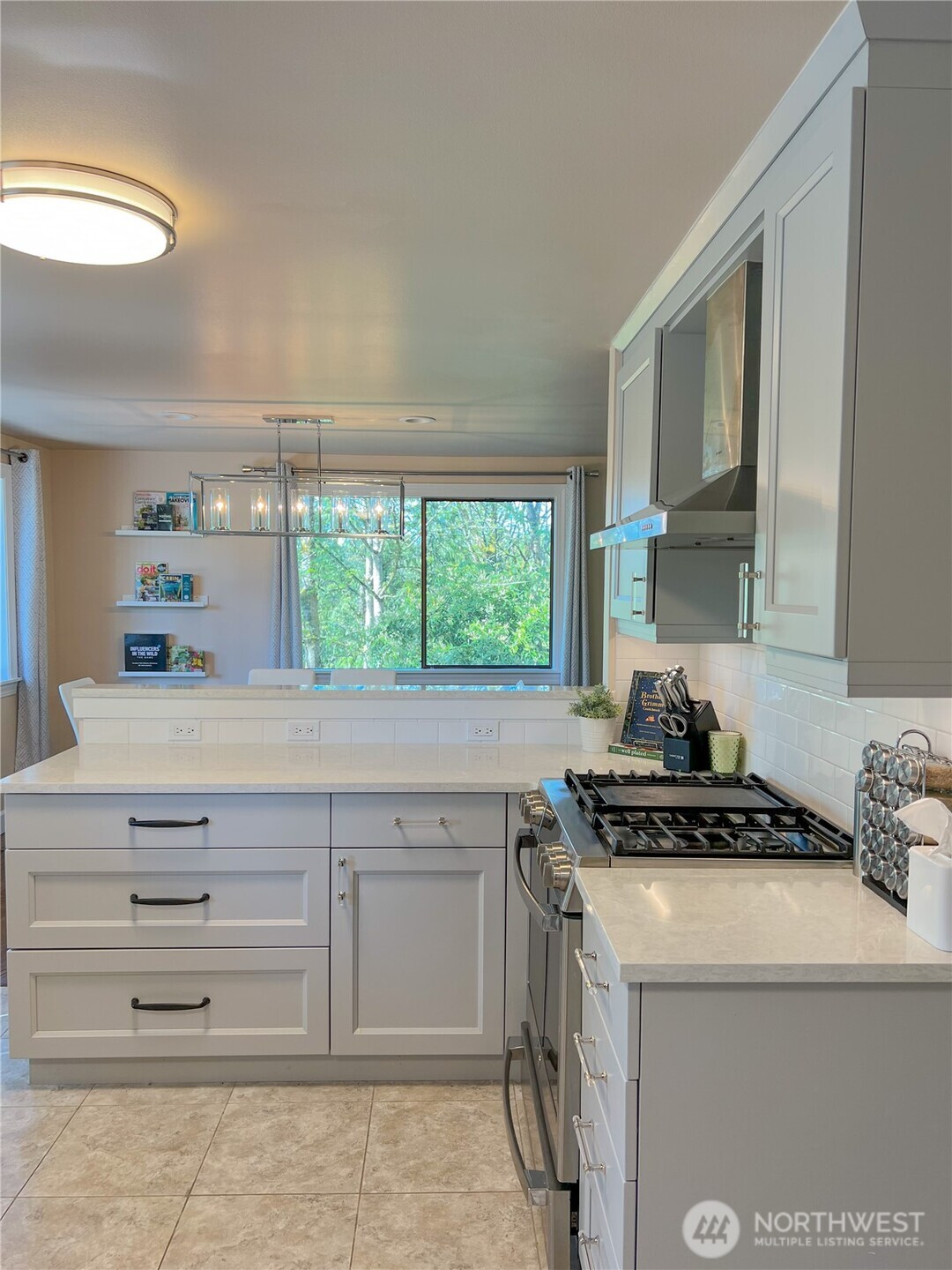 9550 132nd Avenue Southeast Renton, WA 98059 - Photo 14 of 34 a kitchen with granite countertop a stove a sink and a refrigerator