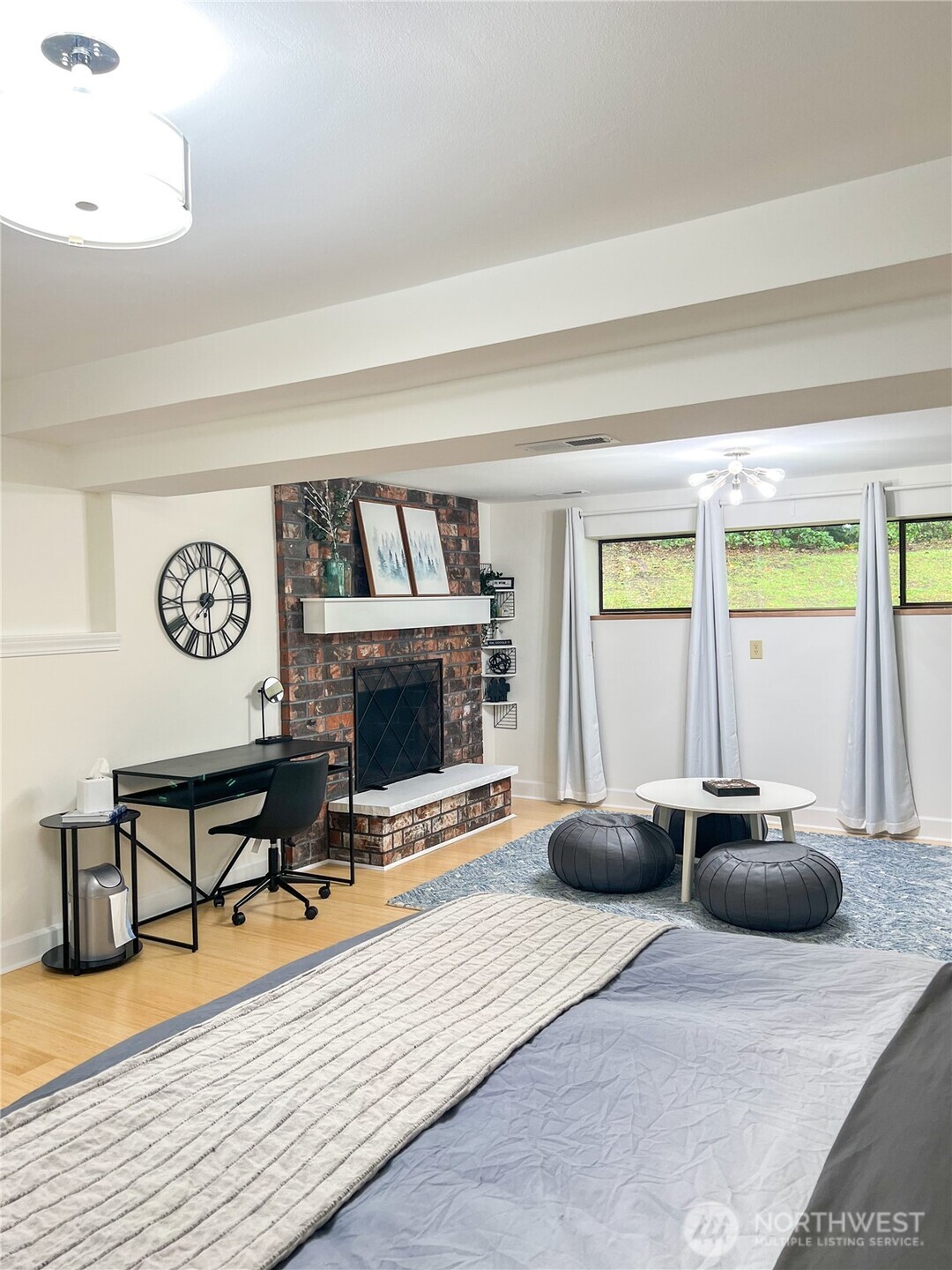 9550 132nd Avenue Southeast Renton, WA 98059 - Photo 21 of 34 a living room with furniture a flat screen tv and a fireplace
