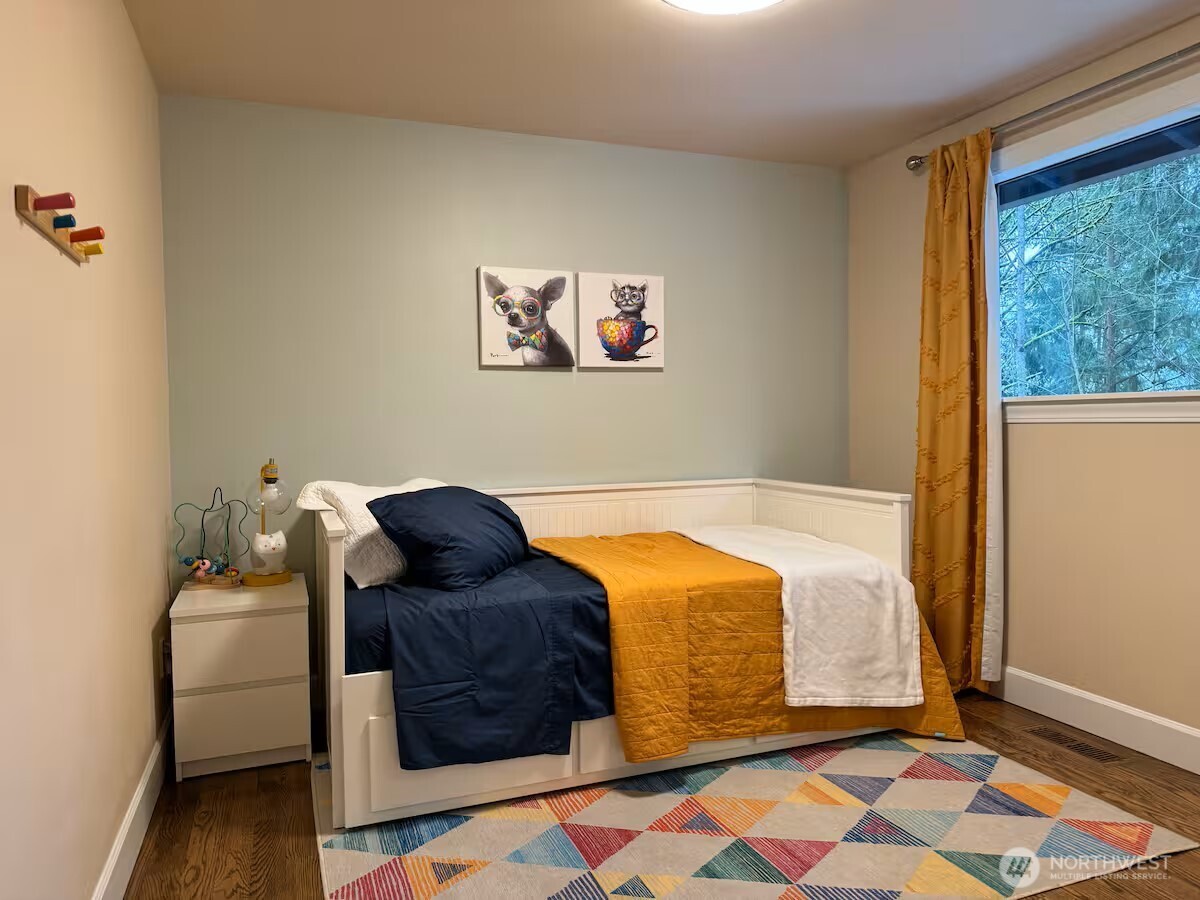 9550 132nd Avenue Southeast Renton, WA 98059 - Photo 26 of 34 a bedroom with a bed and wooden floor