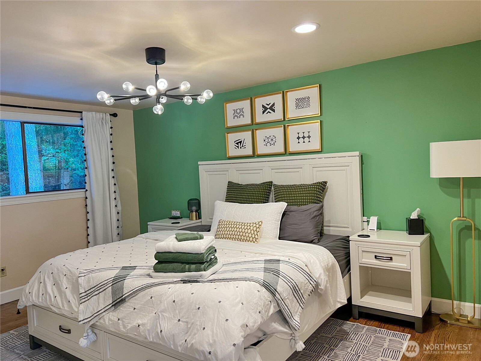 9550 132nd Avenue Southeast Renton, WA 98059 - Photo 9 of 34 a bedroom with a bed and a chandelier