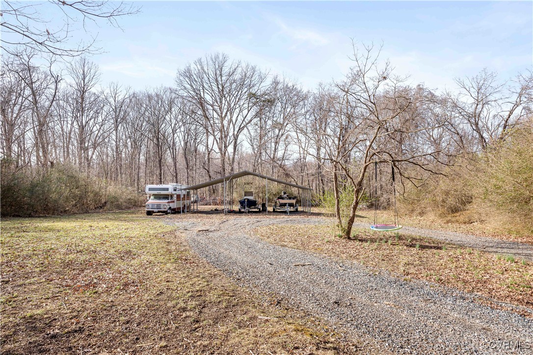Yard w/ massive three bay carport perfect for boat