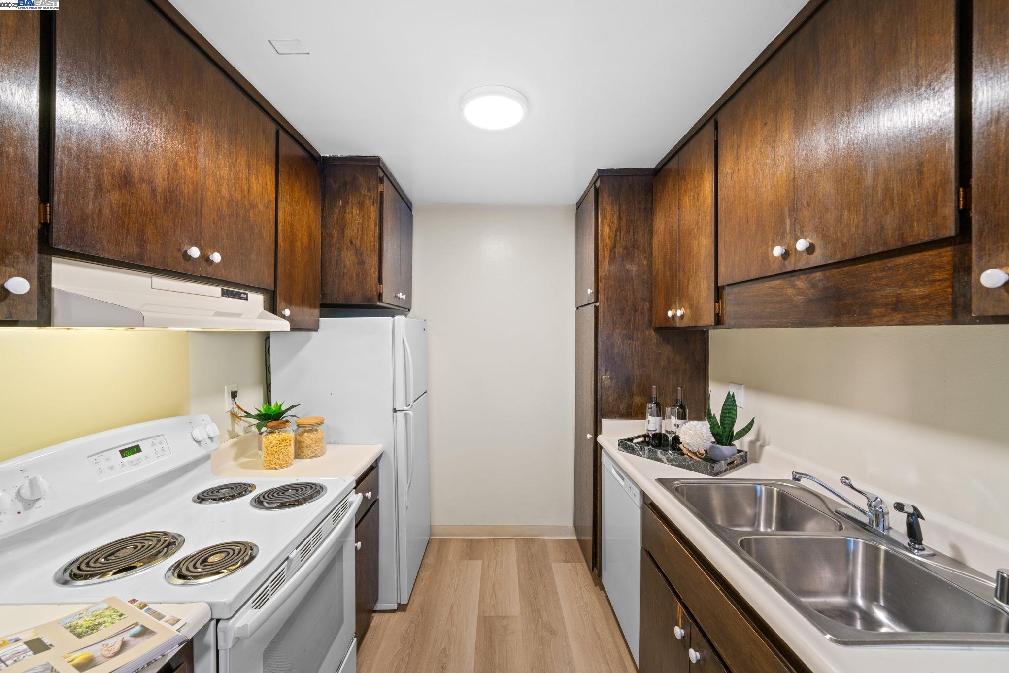 1327 Webster Street, Unit B101 Alameda, CA 94501 - Photo 11 of 26 a kitchen that has a sink and a stove