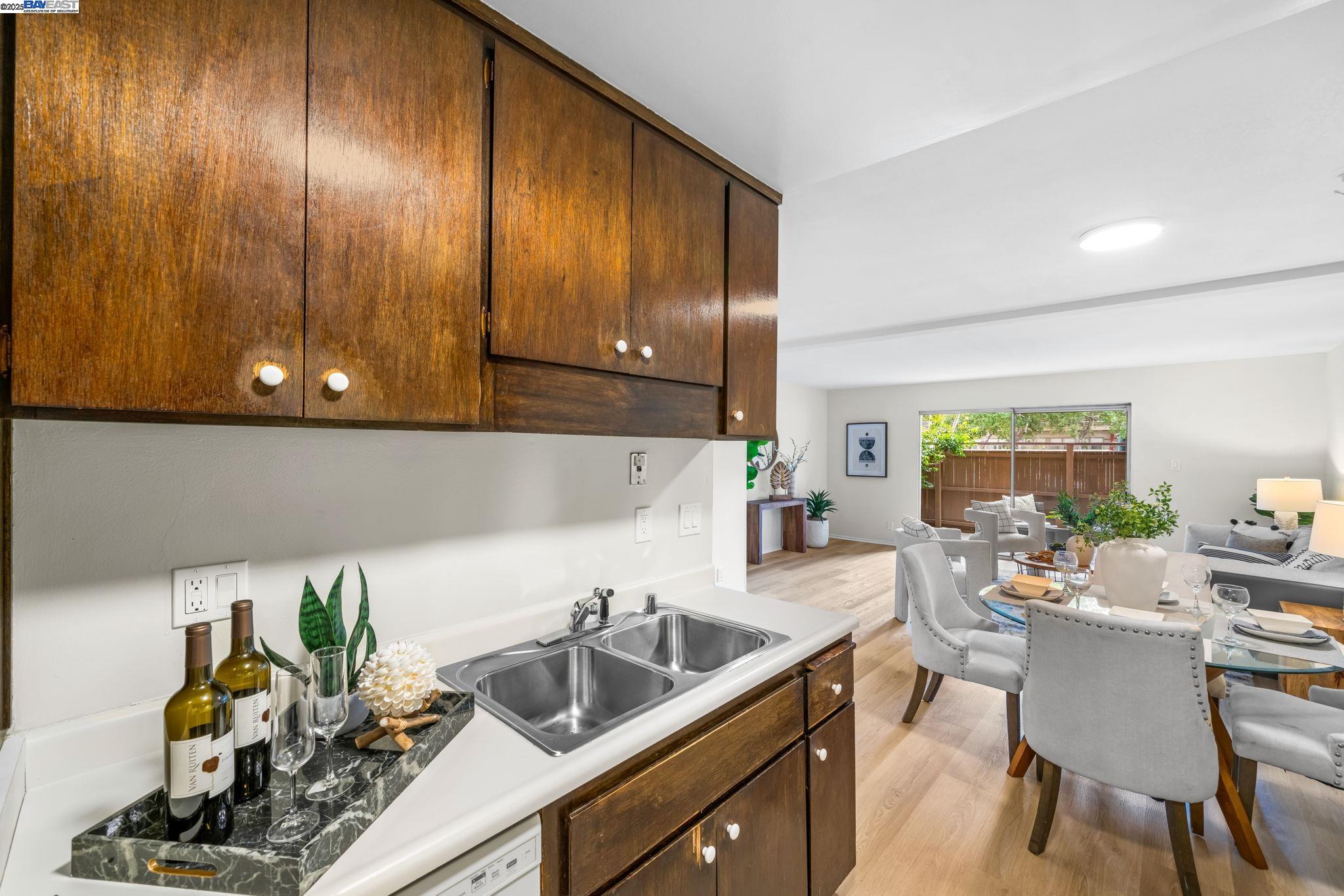 1327 Webster Street, Unit B101 Alameda, CA 94501 - Photo 12 of 26 a kitchen with sink cabinets and potted plant