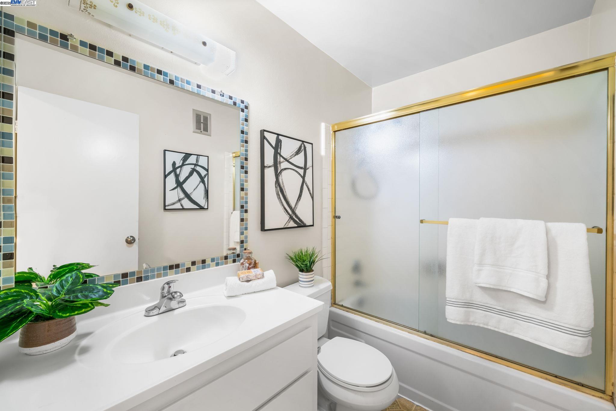 1327 Webster Street, Unit B101 Alameda, CA 94501 - Photo 16 of 26 a bathroom with a sink and a mirror