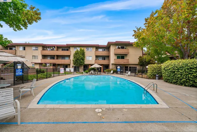 a view of swimming pool with outdoor seating and a patio