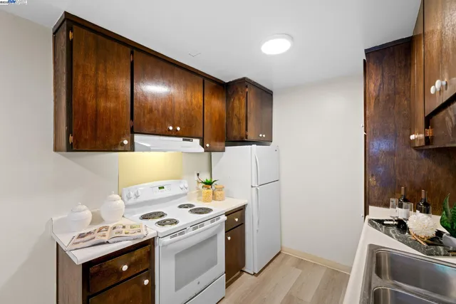 a kitchen with a stove and a refrigerator