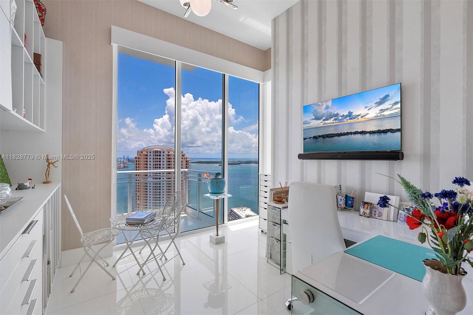 900 Brickell Key Boulevard, Unit 3103 Miami, FL 33131 - Photo 15 of 55 a living room with furniture and a flat screen tv