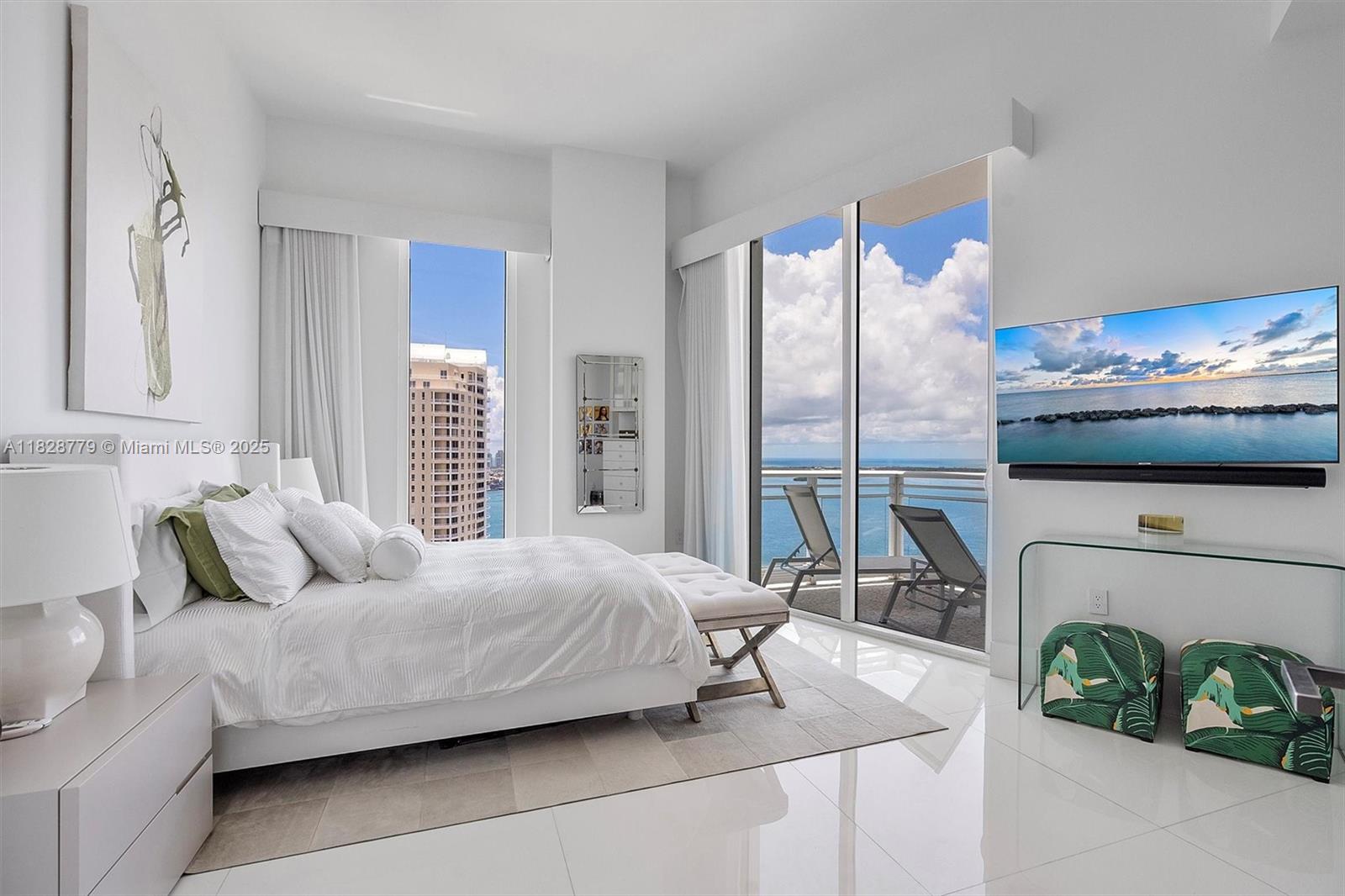 900 Brickell Key Boulevard, Unit 3103 Miami, FL 33131 - Photo 17 of 55 a bedroom with a bed and a window