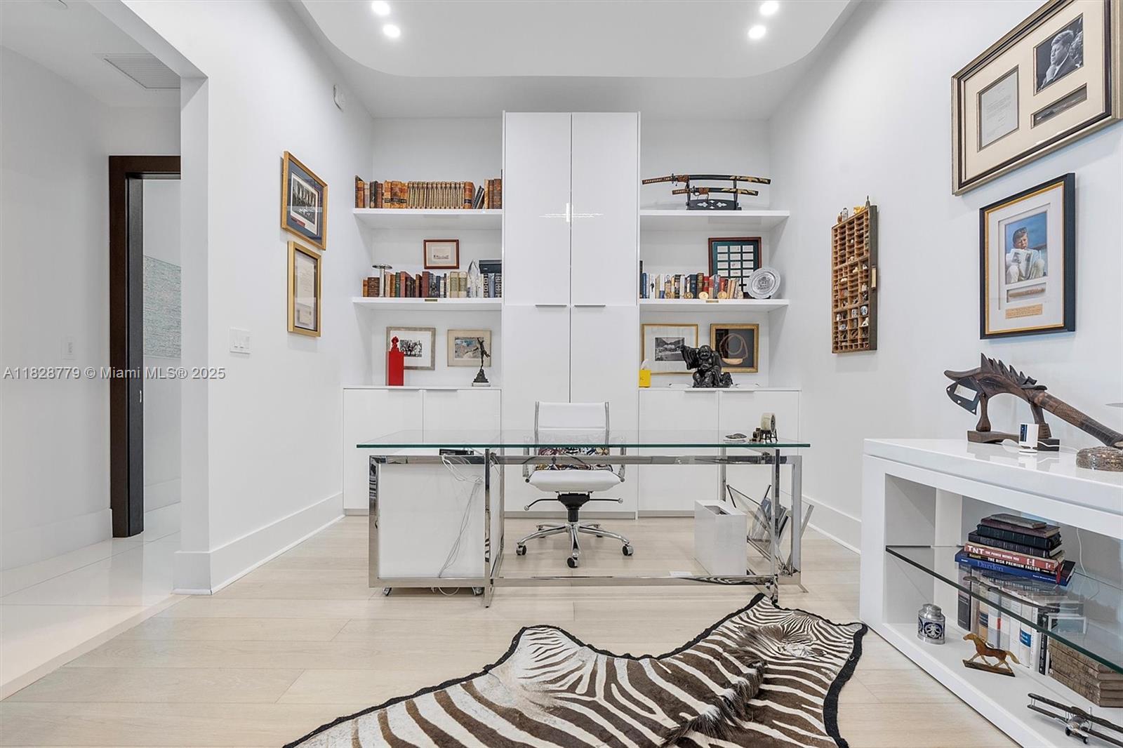 900 Brickell Key Boulevard, Unit 3103 Miami, FL 33131 - Photo 19 of 55 a living room with furniture and a book shelf