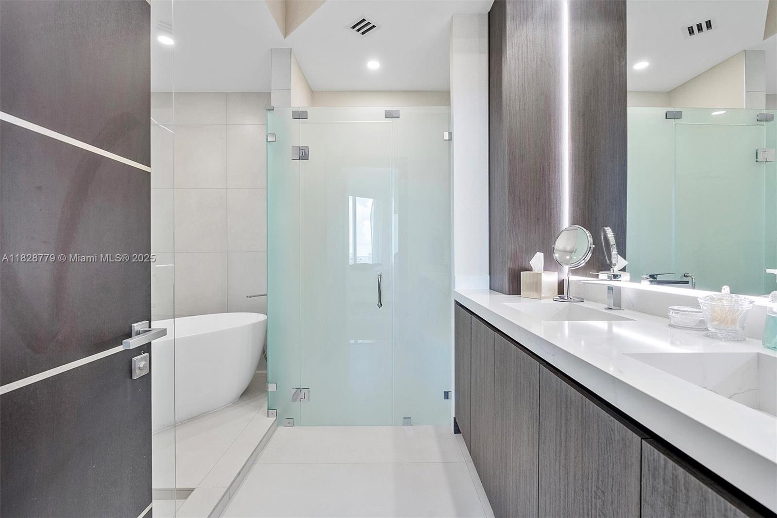 900 Brickell Key Boulevard, Unit 3103 Miami, FL 33131 - Photo 22 of 55 a bathroom with a double vanity sink and mirror