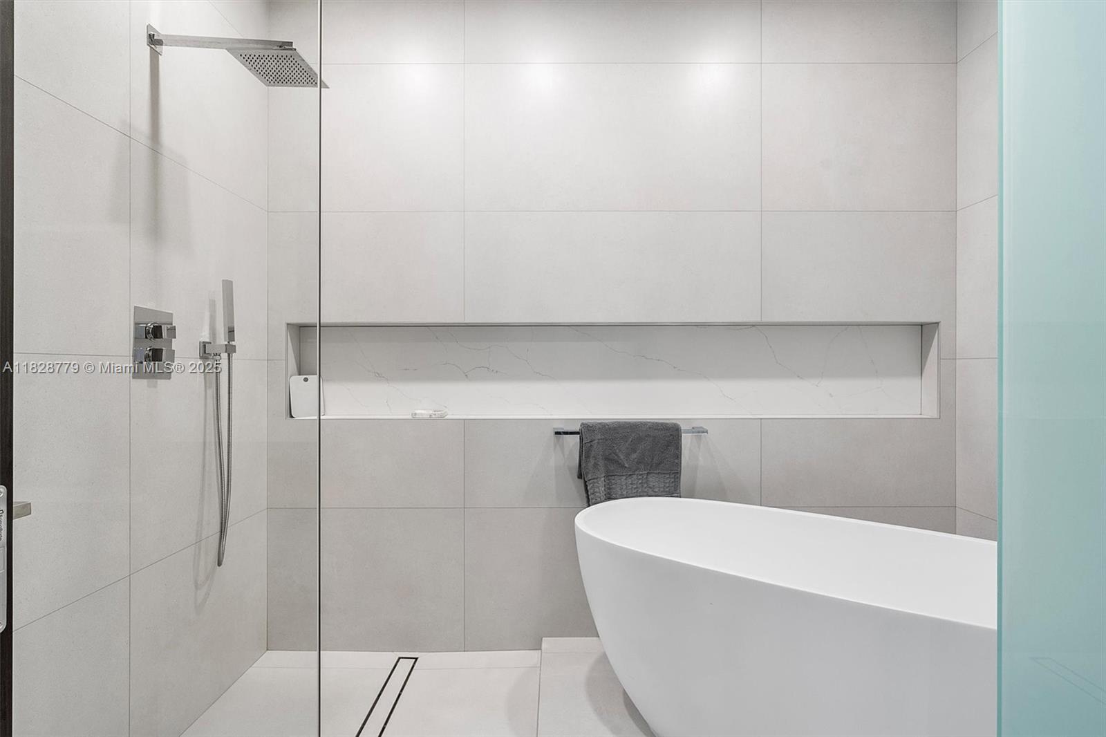 900 Brickell Key Boulevard, Unit 3103 Miami, FL 33131 - Photo 23 of 55 a bathroom with a bathtub