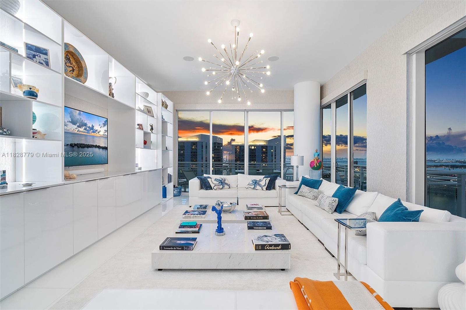 900 Brickell Key Boulevard, Unit 3103 Miami, FL 33131 - Photo 34 of 55 a living room with furniture chandelier and a large window