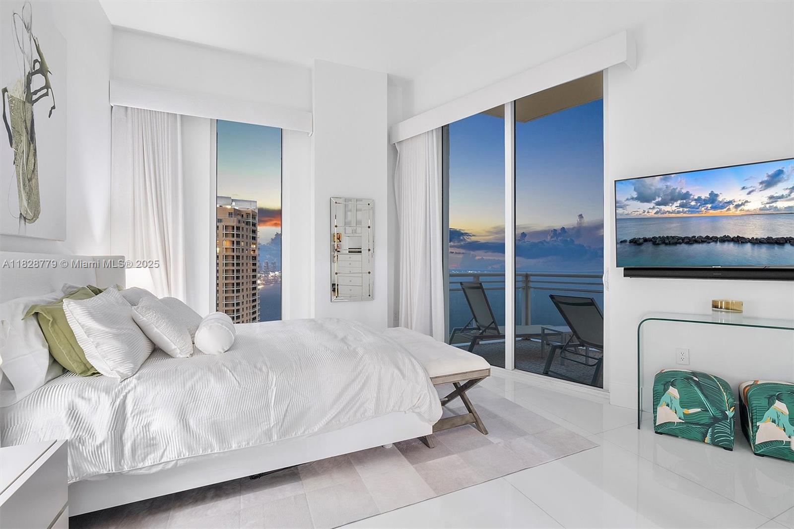 900 Brickell Key Boulevard, Unit 3103 Miami, FL 33131 - Photo 37 of 55 a bedroom with a bed and a television