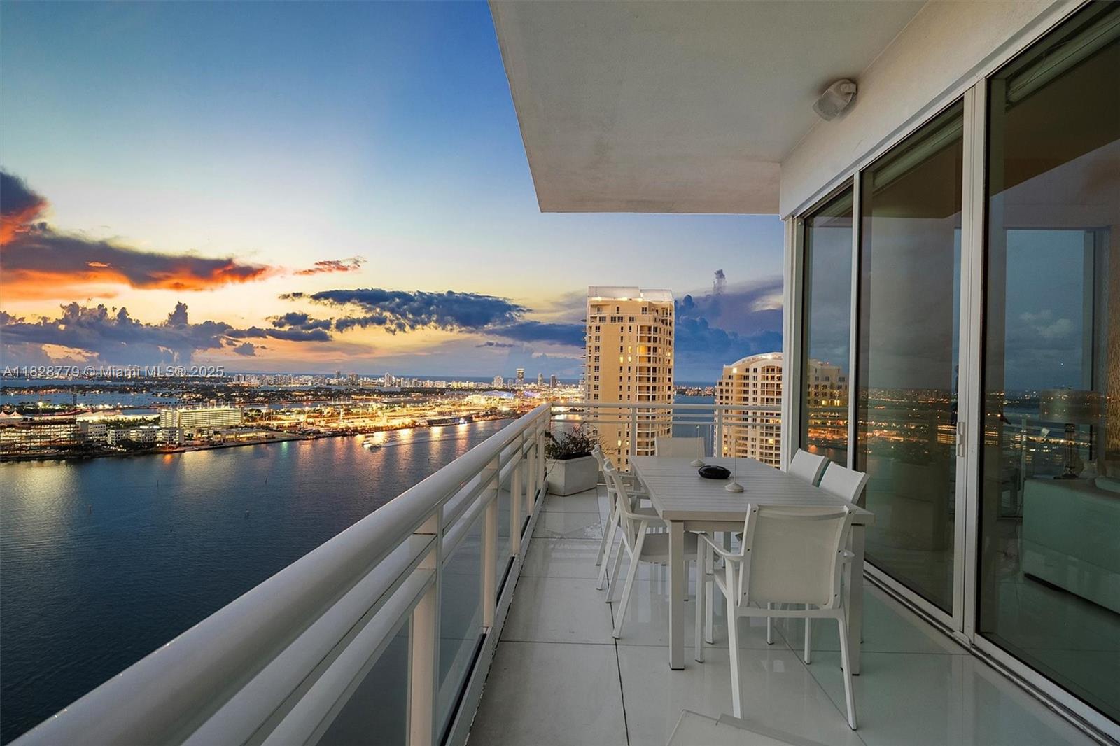 900 Brickell Key Boulevard, Unit 3103 Miami, FL 33131 - Photo 39 of 55 a view of swimming pool with outdoor seating and lake view