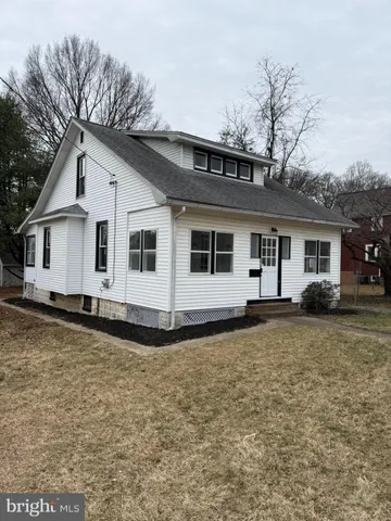 a kitchen with white cabinets and sink