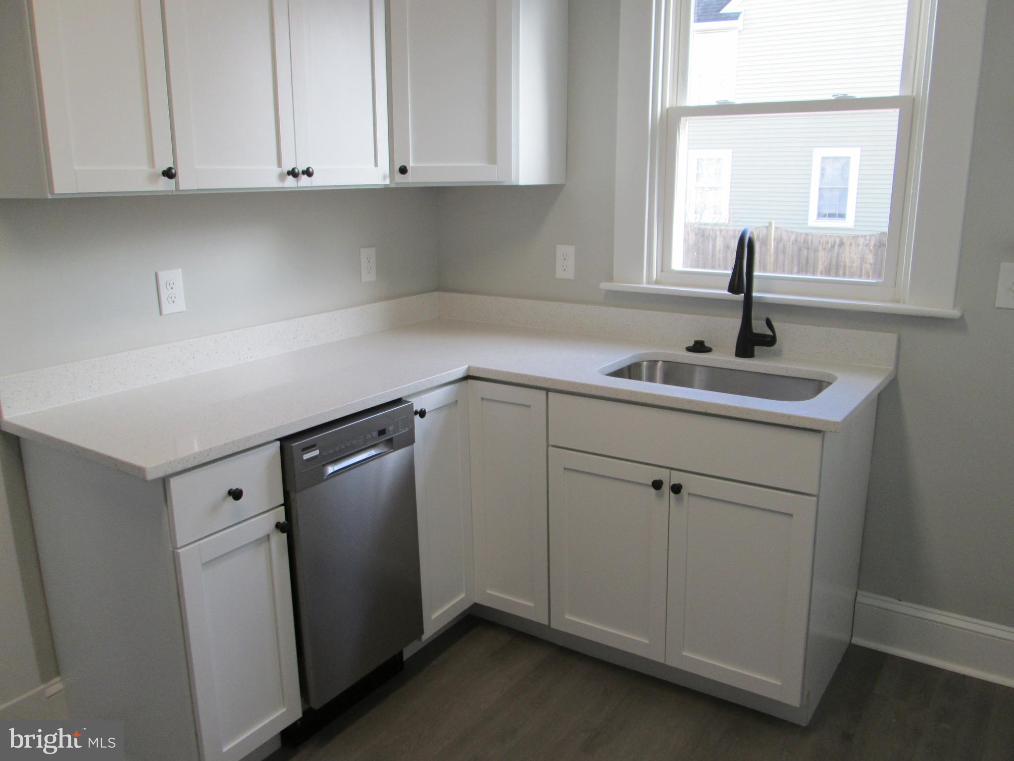 205 Wicklow Road Glen Burnie, MD 21061 - Photo 2 of 52 a kitchen with white cabinets and sink