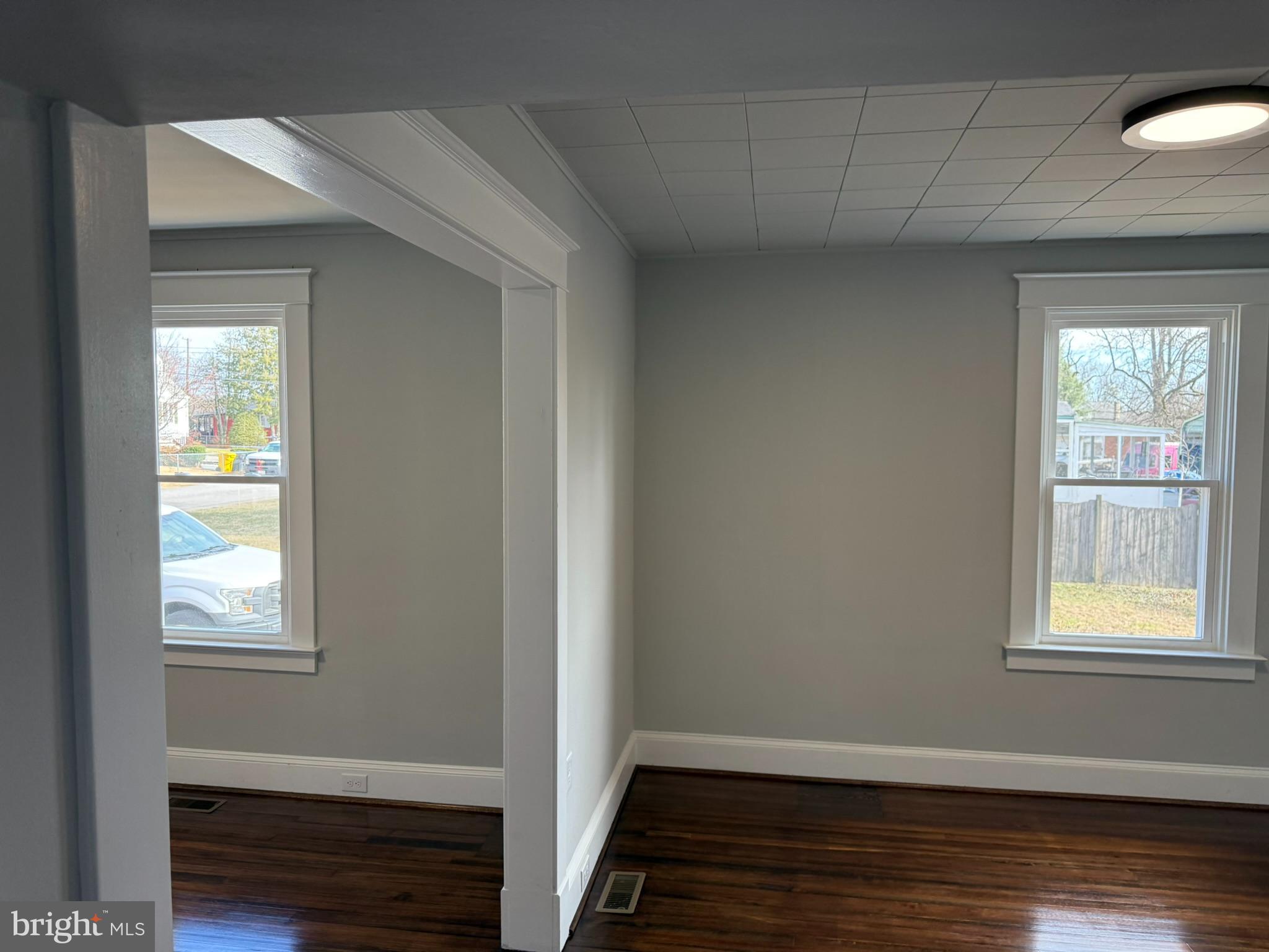 205 Wicklow Road Glen Burnie, MD 21061 - Photo 27 of 52 a view of an empty room with wooden floor and a window