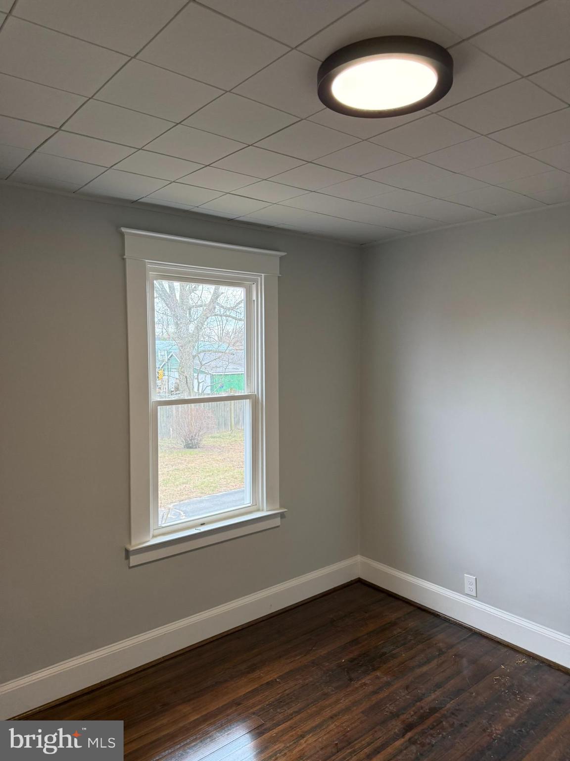 205 Wicklow Road Glen Burnie, MD 21061 - Photo 28 of 52 an empty room with wooden floor and windows