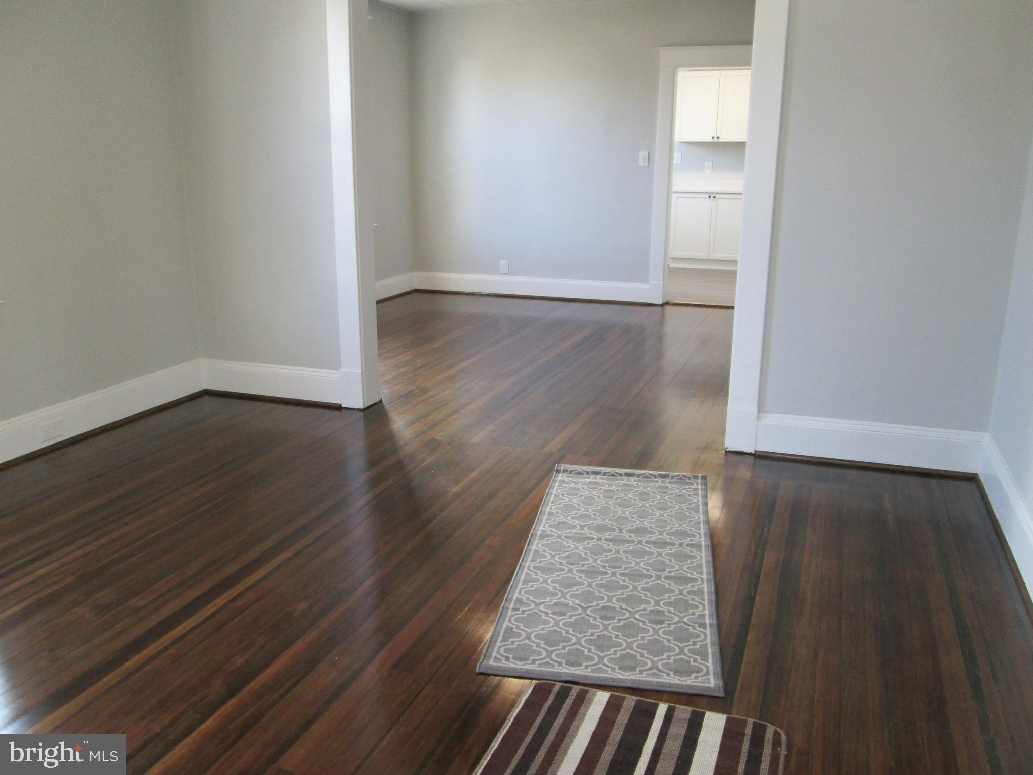 205 Wicklow Road Glen Burnie, MD 21061 - Photo 3 of 52 wooden floor in a hall with an empty room