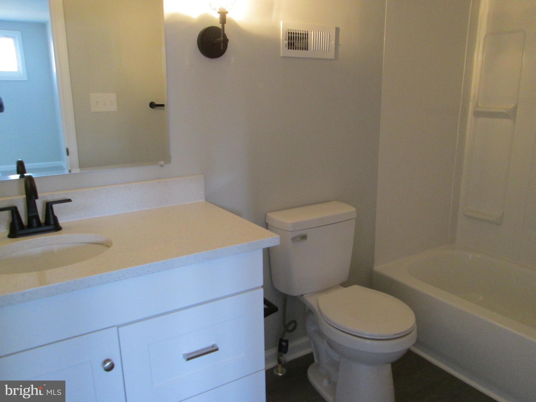 205 Wicklow Road Glen Burnie, MD 21061 - Photo 8 of 52 a bathroom with a sink a toilet and shower