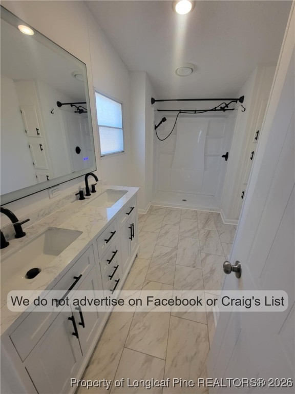 910 Blue Road Parkton, NC 28371 - Photo 9 of 12 a bathroom with a sink a mirror and shower