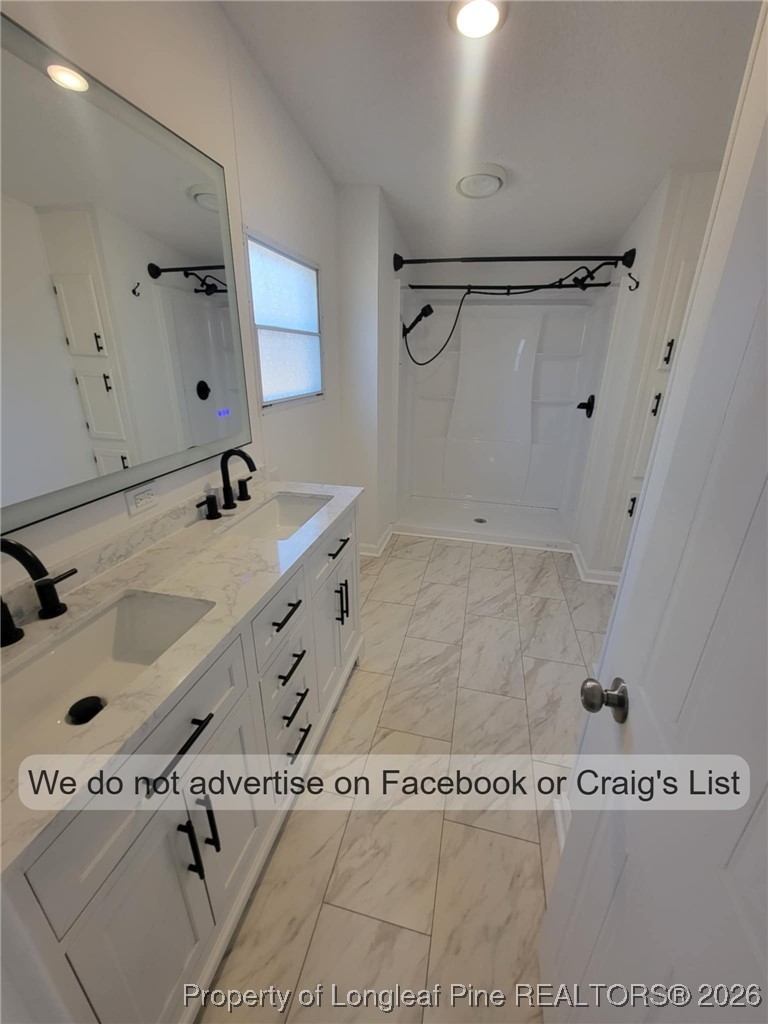 910 Blue Road Parkton, NC 28371 - Photo 9 of 12 a bathroom with a sink a vanity and a mirror