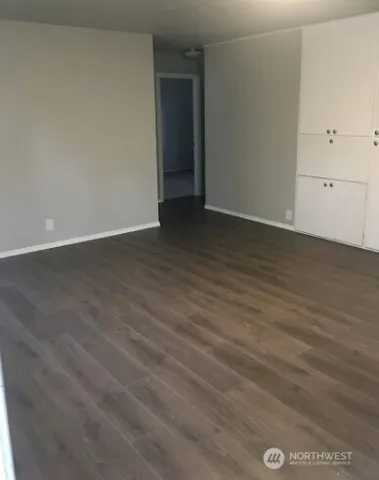 an empty room with wooden floor
