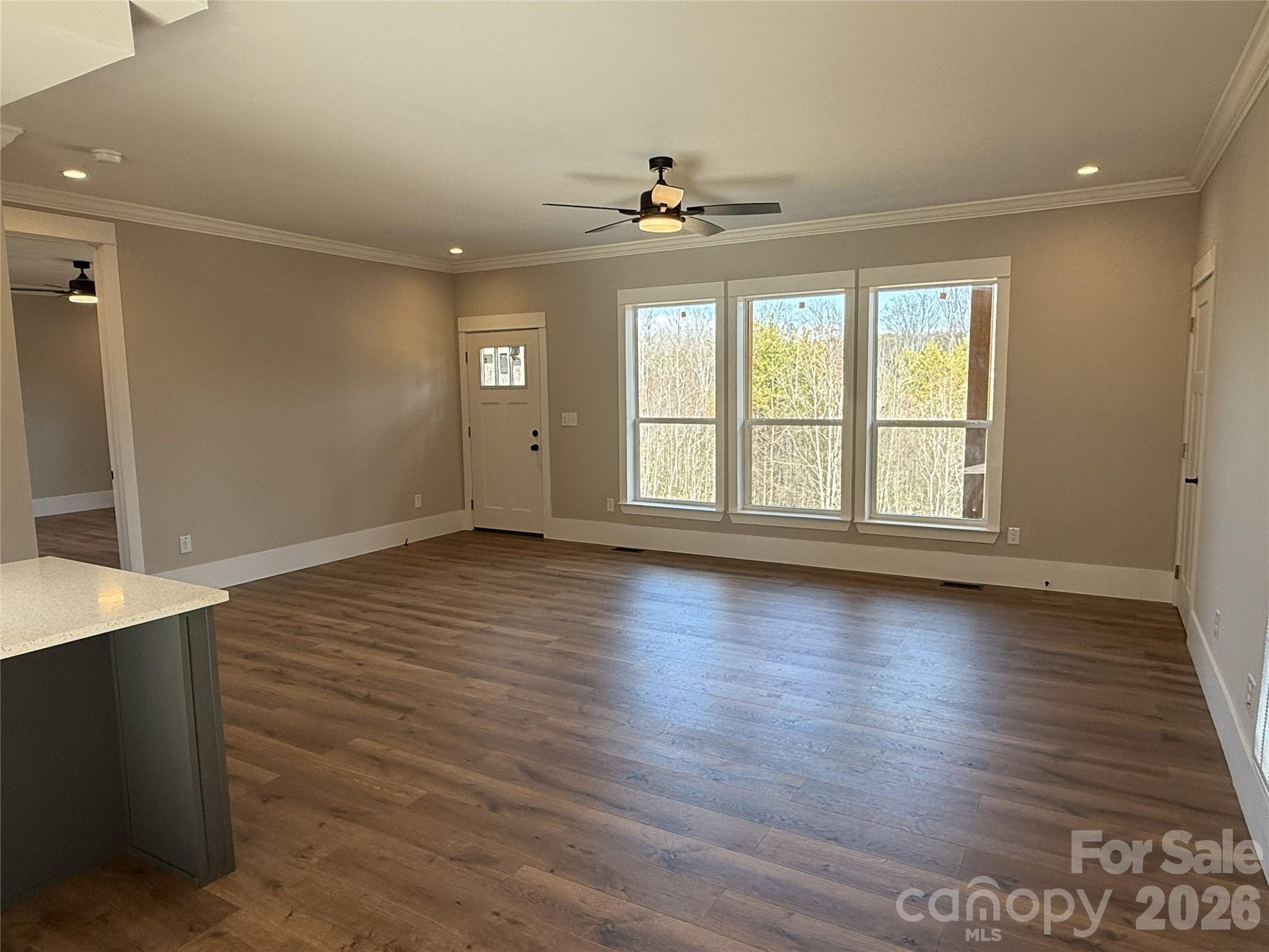 4271 Alpine Trail Morganton, NC 28655 - Photo 11 of 36 an empty room with wooden floor and windows