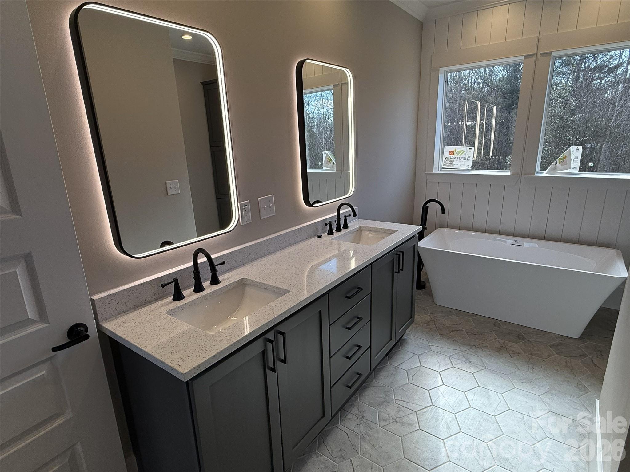 4271 Alpine Trail Morganton, NC 28655 - Photo 5 of 36 a bathroom with a double vanity sink a mirror and a bathtub