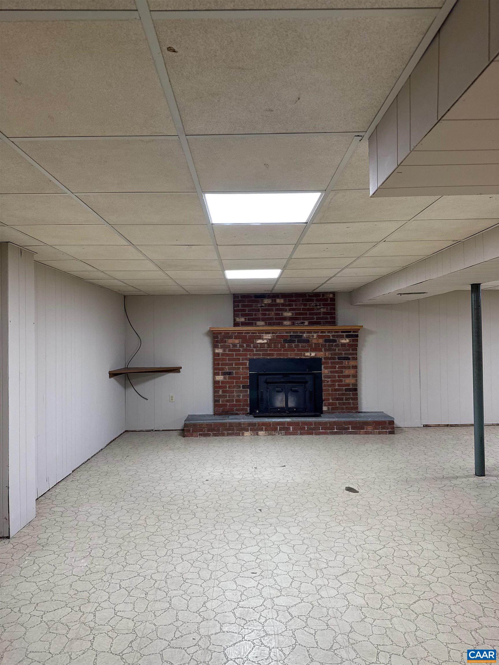 18143 Monrovia Road Orange, VA 22960 - Photo 26 of 43 an empty room with furniture and a fireplace