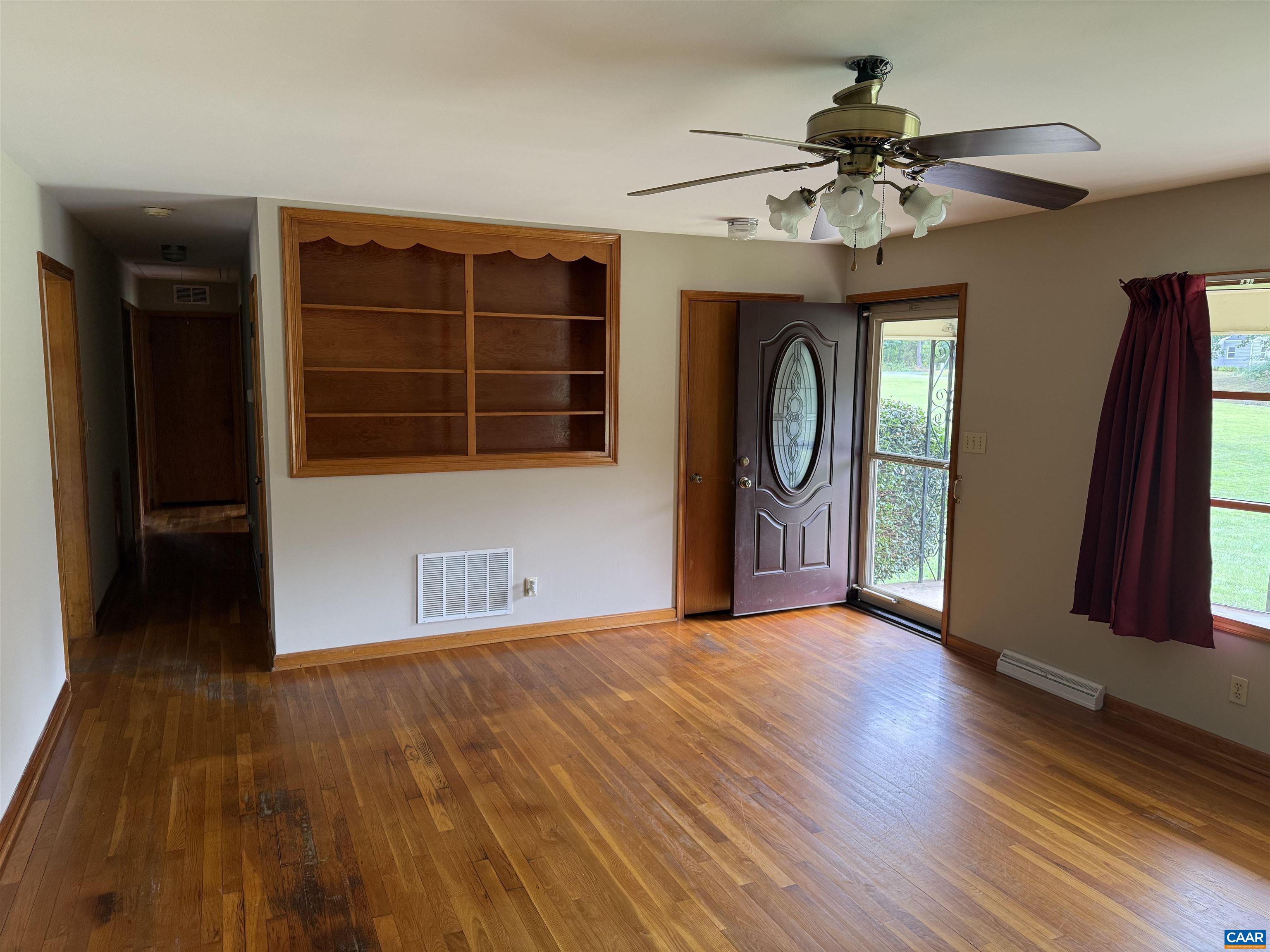 18143 Monrovia Road Orange, VA 22960 - Photo 5 of 43 a view of a livingroom with a ceiling fan and wooden floor